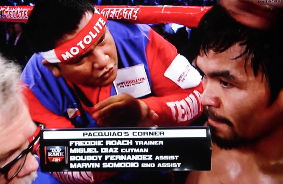 Asst Trainer Buboy Fernandez repeats Roach’s instructions in Filipino at Pacquiao’s corner.